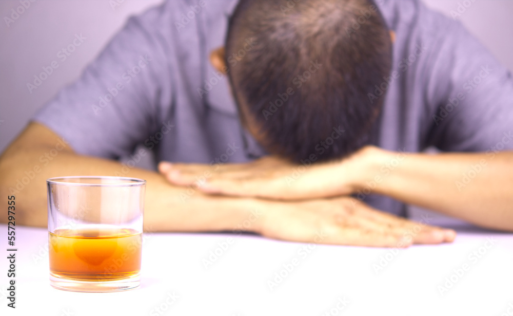 Glasses of whiskey and background images are male headaches. The result of excessive alcohol consumption. Glasses of whiskey and background images are male headaches. The result of excessive alcohol consumption.