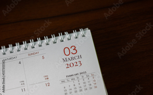 Top view shot of a 2023 calendar, "March page". Selective focus shot of a calendar, focused on "03, March, 2023".