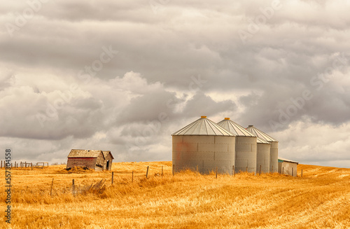 Stormy famland landscape of grain silos and old barns