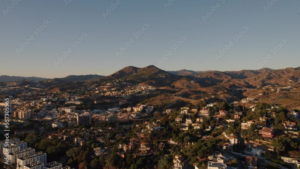 Aerial forward moving drone shot over El Candado city in Malaga Spain. Beautiful sunlight on city hills and residences Aerial forward moving drone shot over El Candado city in Malaga Spain. Beautiful sunlight on city hills and residences