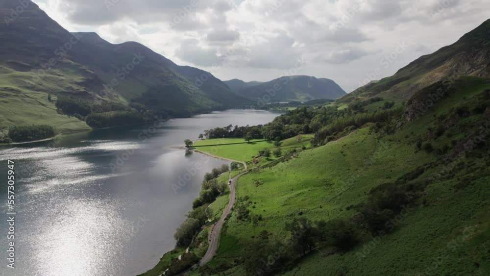 Drone shot flying backwards along the hills next to Crummock Water on a sunny day, Lake District, Cumbria, UK Drone shot flying backwards along the hills next to Crummock Water on a sunny day, Lake District, Cumbria, UK