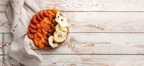 Fototapeta Naklejka Na Ścianę i Meble -  Tray with dried fruits on white wooden background with space for text