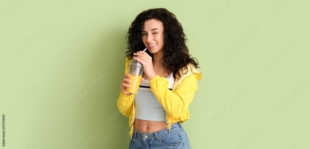 Portrait of stylish young woman with cup of fruit smoothie on color background Portrait of stylish young woman with cup of fruit smoothie on color background