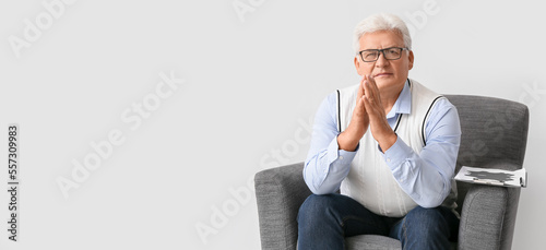 Male psychologist sitting i...