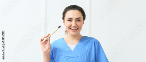Female dentist with toothbr...