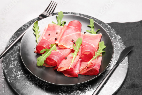 Plate with slices of tasty ham on light background, closeup