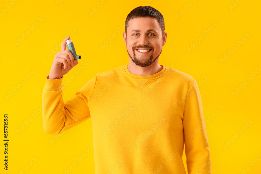Man with inhaler on yellow background Man with inhaler on yellow background