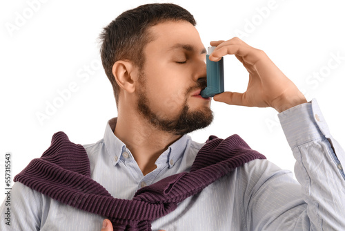 Young man using asthma inha...