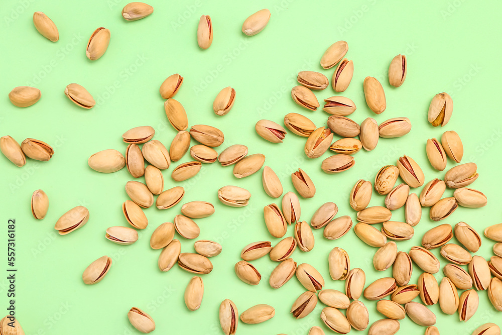 Heap of pistachio nuts on green background Heap of pistachio nuts on green background