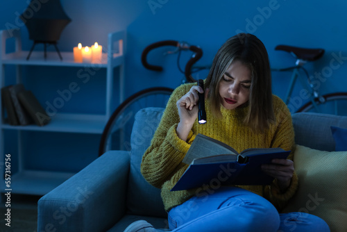 Young woman reading book wi...