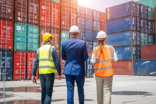 Photography Engineer and businessman checking a quality of containers box from cargo ship for export and import,Container Shipping Logistics Engineering concept