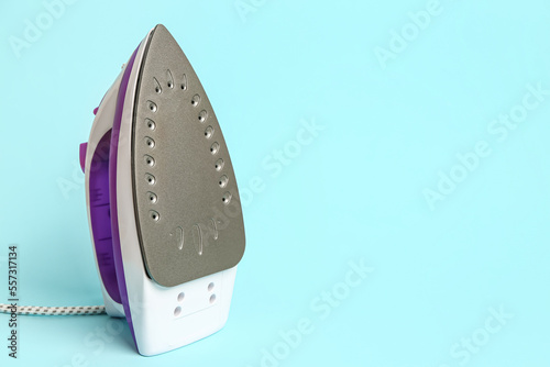 Electric iron on blue background