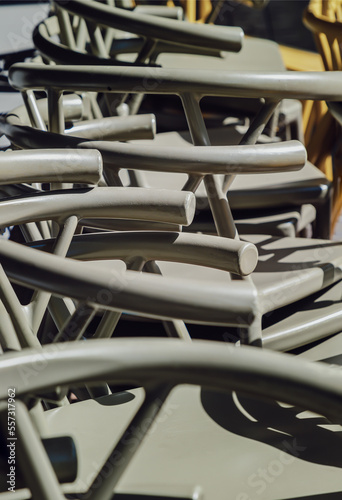 Detail of Stack of Dark green (Khaki color) plastic chairs.
