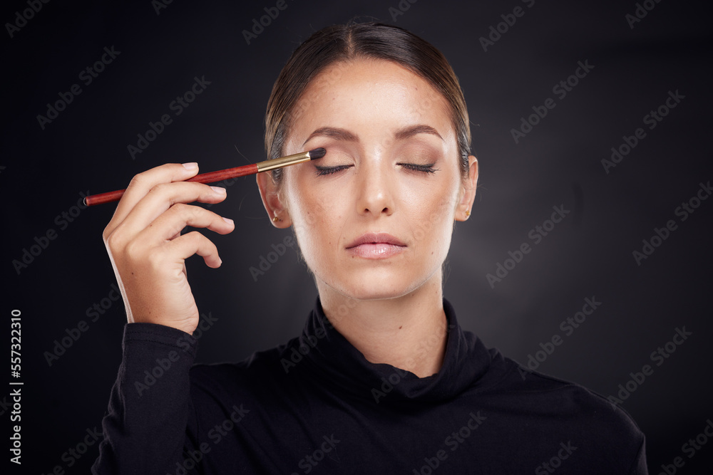 Obraz premium Makeup, brush or model with beauty luxury products or cosmetics for self care in studio on black background. Skincare, relax or young woman brushes foundation powder or eyeliner in facial treatment