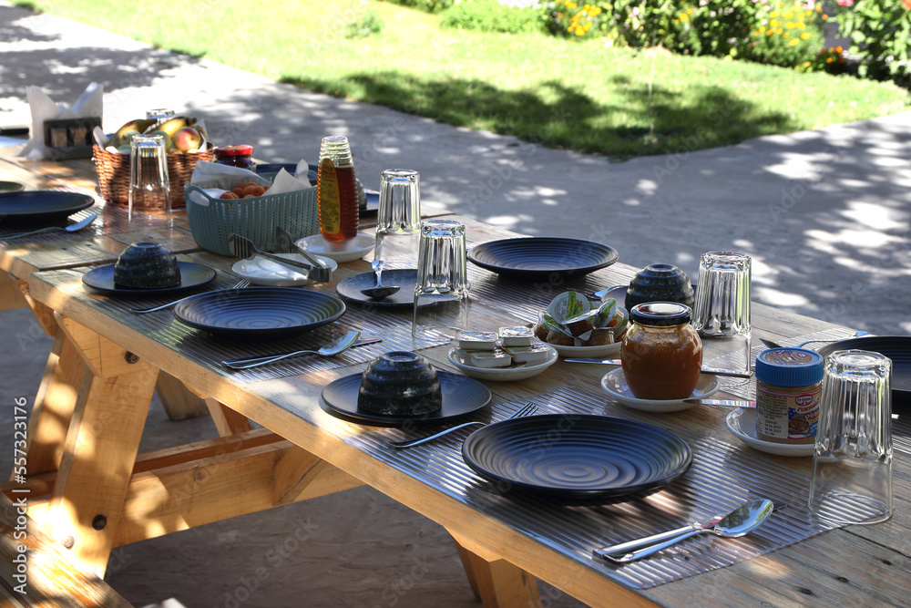 Ready breakfast table in outdoor location.