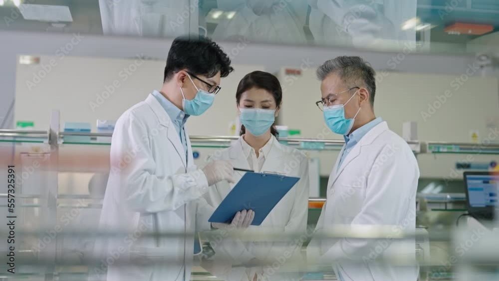 Three Chinese researchers discussing in laboratory,4K Three Chinese researchers discussing in laboratory,4K