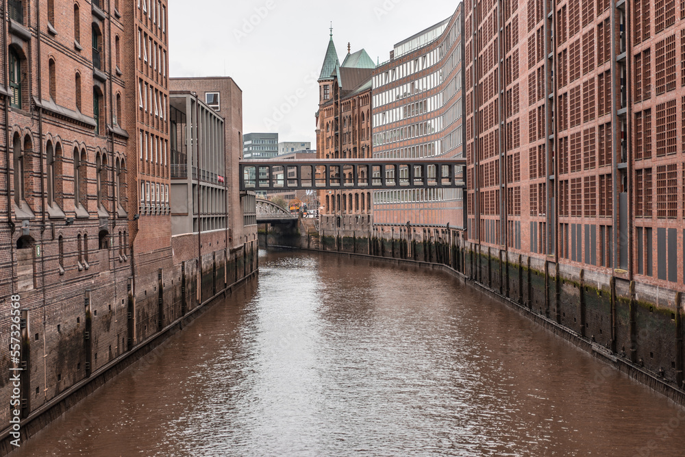 Bridge in Hamburg connecting narrow warehouse buildings in industrial block. Hamburg, Germany