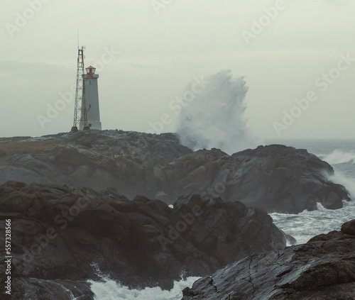 Lonely beacon and stormy sea landscape photo. Beautiful nature scenery photography with grey sky on background. Idyllic scene. High quality picture for wallpaper, travel blog, magazine, article