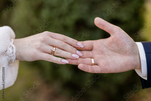 the groom's hand and the bride's hand are held together