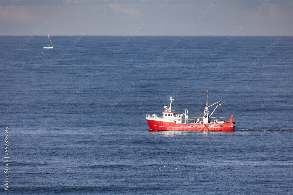 A red cutter the North sea close to Egmond aan Zee, Netherlands
