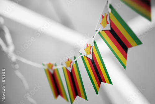 A garland of Zimbabwe national flags on an abstract blurred background