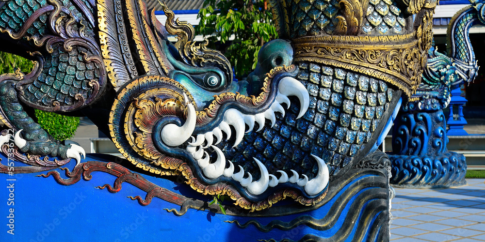 Obraz premium Detail of dragon in Wat Rong Suea Ten, Temple of the Dancing Tiger, in the blue buddhist temple -Chiang Rai-Thailand