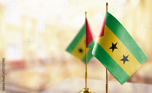 Small flags of the Sao Tome and Principe on an abstract blurry background