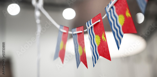 A garland of Kiribati national flags on an abstract blurred background photo