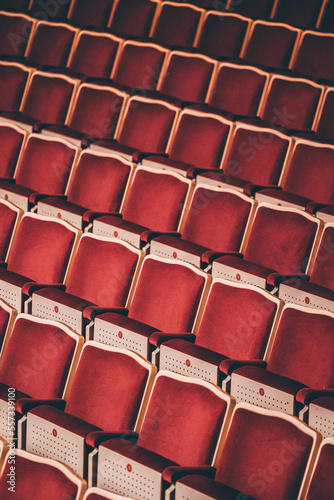 Indoor concert background abstract seats chairs seating in concert hall watching performing music instruments in symphony orchestra