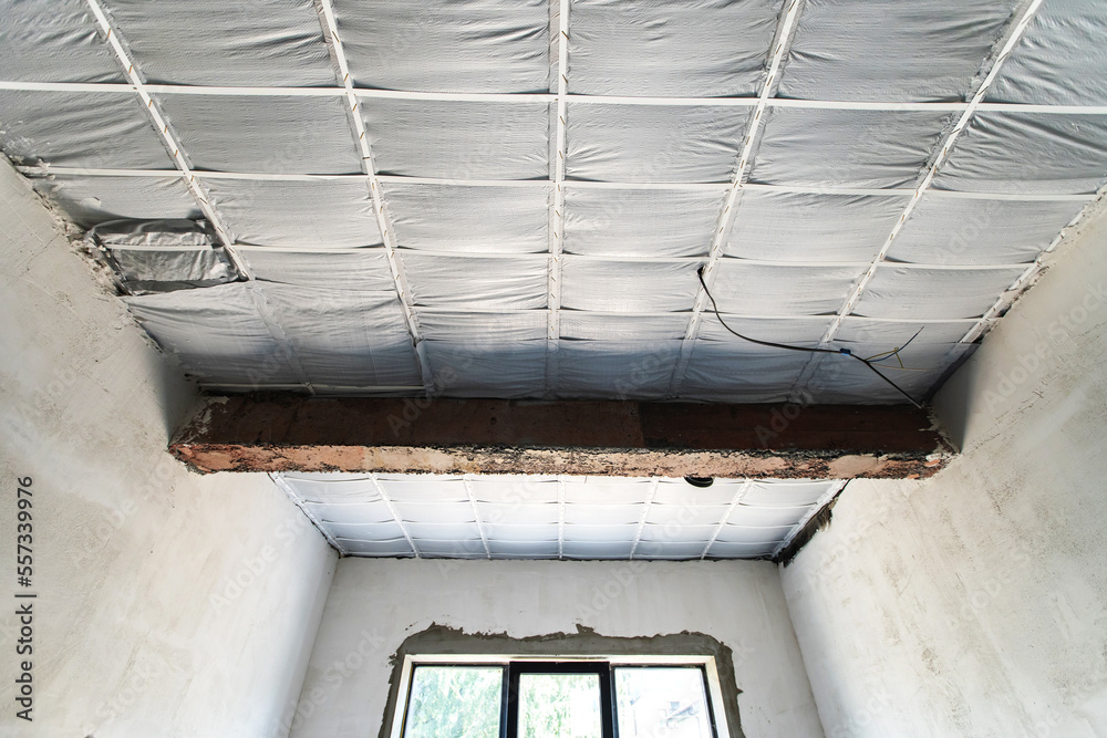 Obraz premium Insulation of the ceiling with heat-insulating materials. Construction and interior decoration of residential premises. Selective focus. Bottom up view