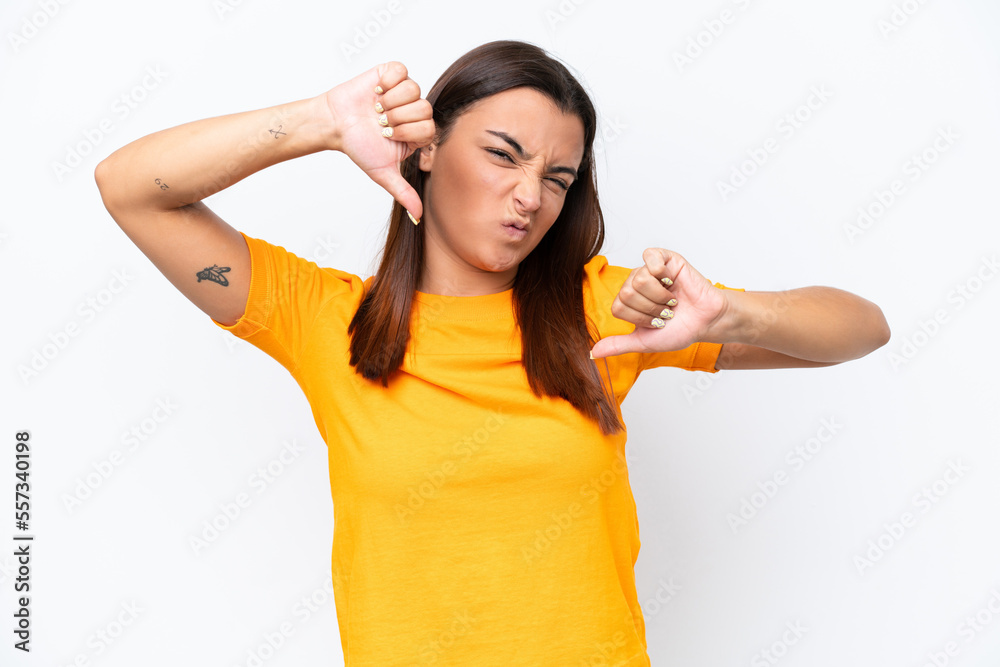 Young caucasian woman isolated on white background showing thumb down with two hands Young caucasian woman isolated on white background showing thumb down with two hands