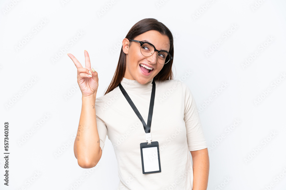 Young caucasian woman with ID card isolated on white background smiling and showing victory sign Young caucasian woman with ID card isolated on white background smiling and showing victory sign