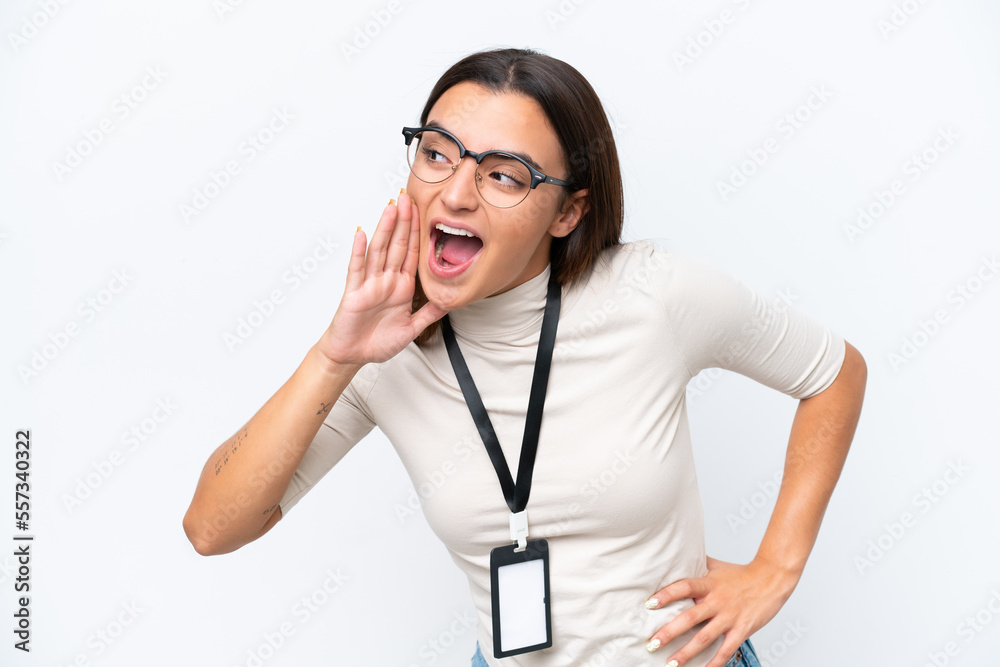 Young caucasian woman with ID card isolated on white background shouting with mouth wide open to the side