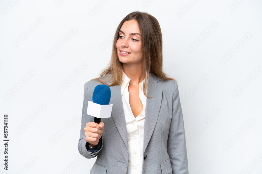 Young TV presenter caucasian woman isolated on white background looking to the side and smiling Young TV presenter caucasian woman isolated on white background looking to the side and smiling