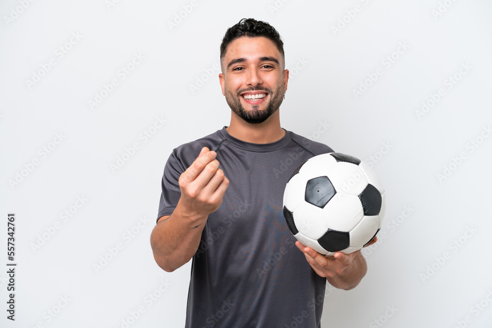 Arab young football player man isolated on white background making money gesture Arab young football player man isolated on white background making money gesture