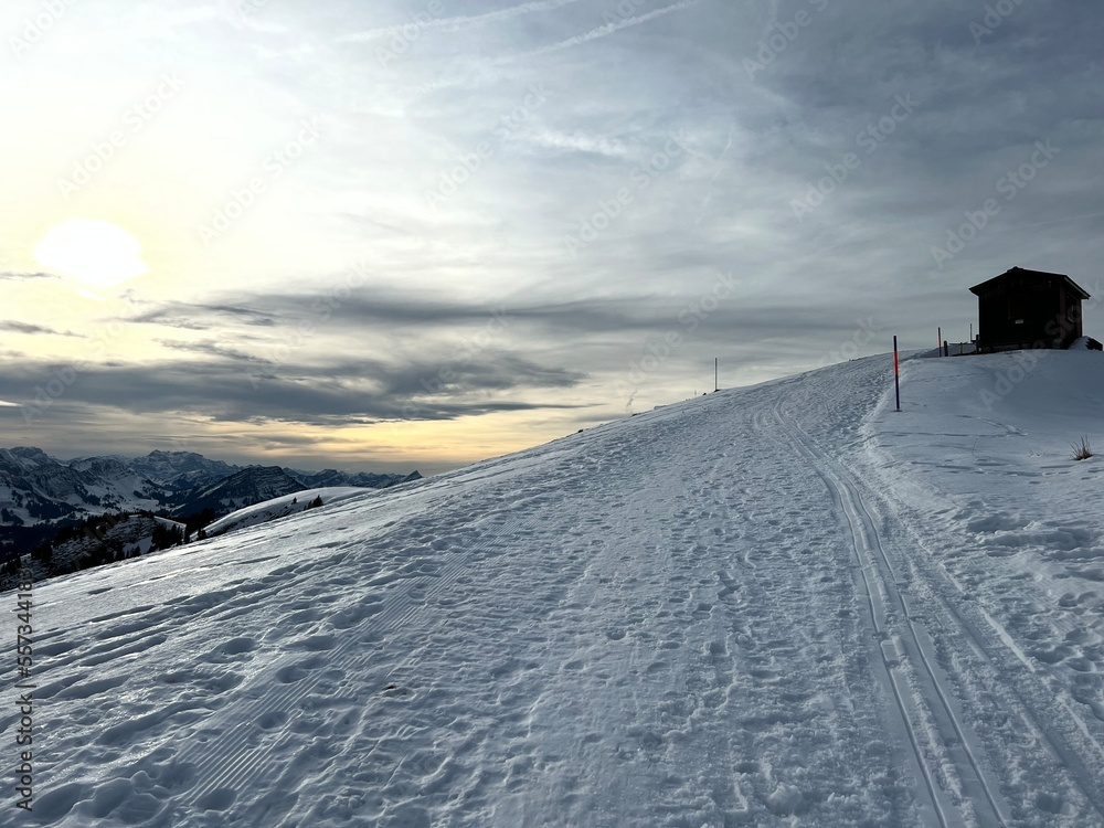 Winter snow idyll along the toboggan run (Kronberg Schlittelweg) on the Kronberg mountain in the Swiss Appenzell Alps massif, Urnäsch (Urnaesch or Urnasch) - Canton of Appenzell, Switzerland Winter snow idyll along the toboggan run (Kronberg Schlittelweg) on the Kronberg mountain in the Swiss Appenzell Alps massif, Urnäsch (Urnaesch or Urnasch) - Canton of Appenzell, Switzerland