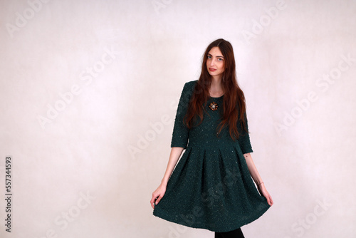 Portrait of young slim woman on grey background