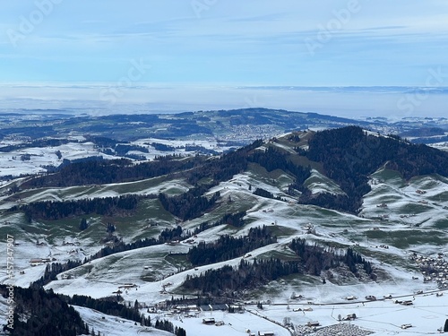 Winter panorama from the top of the Kronberg mountain with a view of the Swiss hills and pastures covered with the first snow, Urnäsch (Urnaesch or Urnasch) - Canton of Appenzell, Switzerland (Schweiz