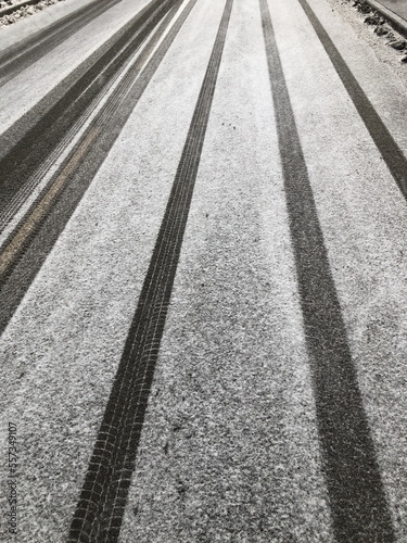 white snowy road with car tracks