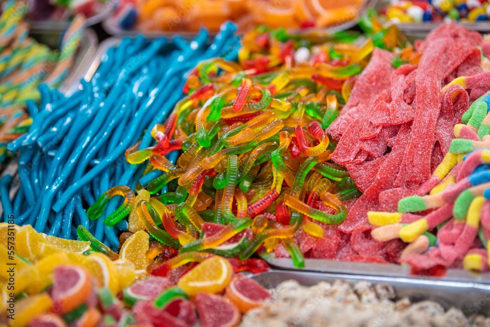 Assorted gummy candies and jellies on street market shop. A lot of colorful jelly sweets candy flavor. Lots of colorful sweets, candies background. Assorted gummy candies and jellies on street market shop. A lot of colorful jelly sweets candy flavor. Lots of colorful sweets, candies background.
