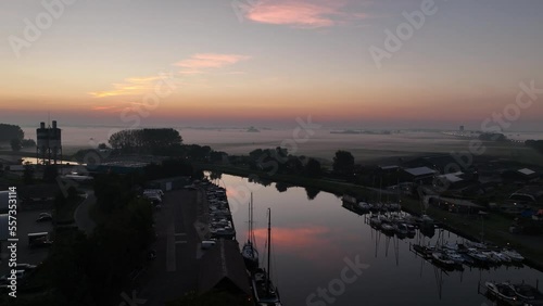 Sun rise in The Netherlands in springsummer, foggy dew in the morning aerial drone overhead view. Holland early morning, start up. Aerial photo