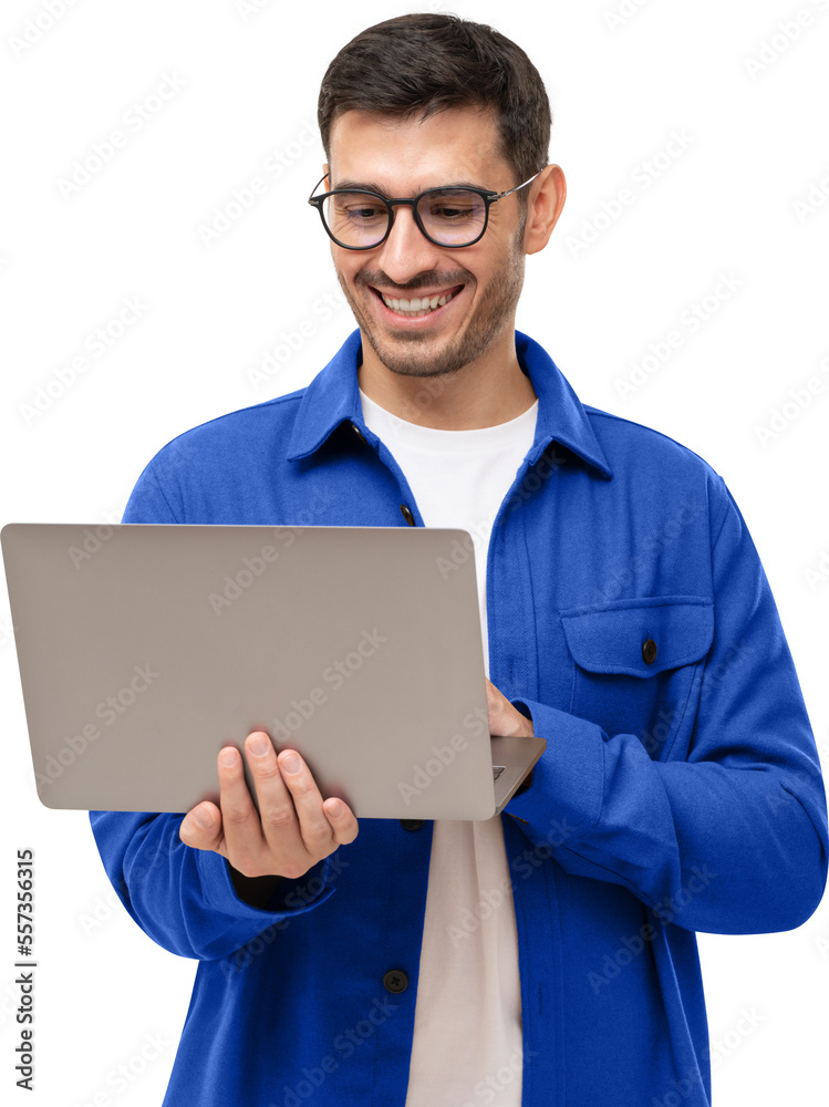 Young happy man standing with opened laptop, browsing online or typing message Young happy man standing with opened laptop, browsing online or typing message