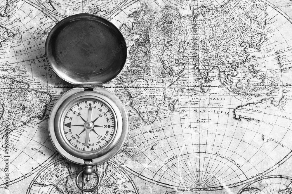 antique brass compass and old map of the world antique brass compass and old map of the world