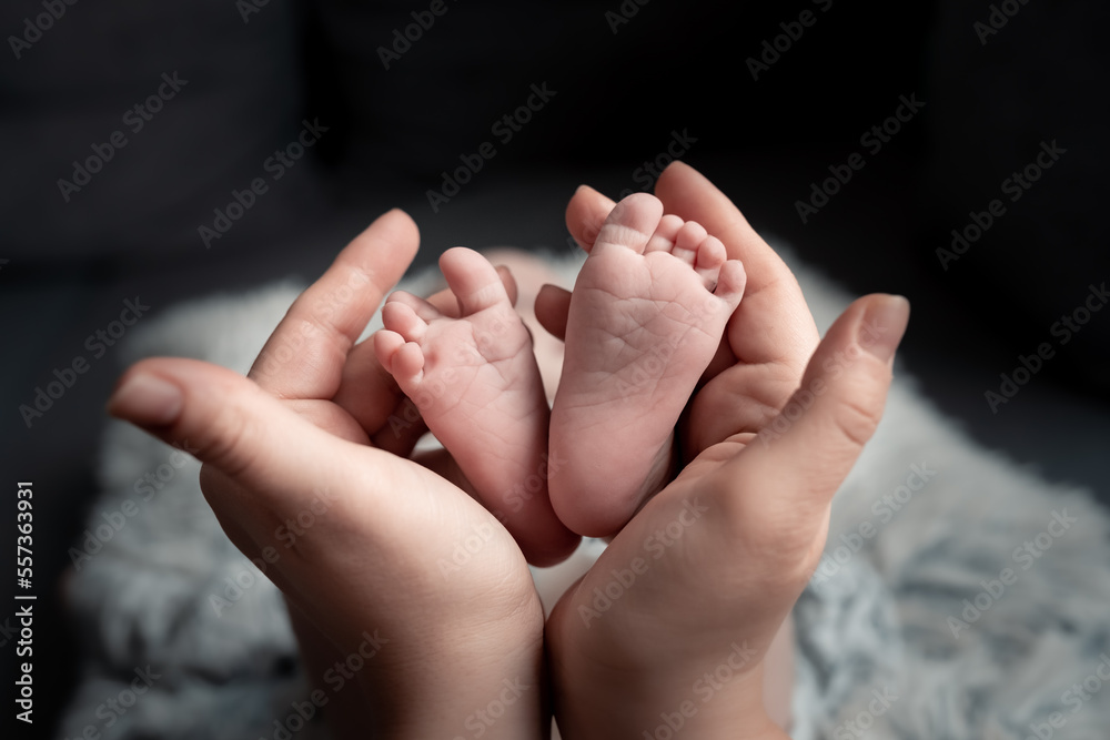Welcome baby,Mother holding her newborn baby foot, love at first sight, baby feels love and security from mother, pro life Welcome baby,Mother holding her newborn baby foot, love at first sight, baby feels love and security from mother, pro life