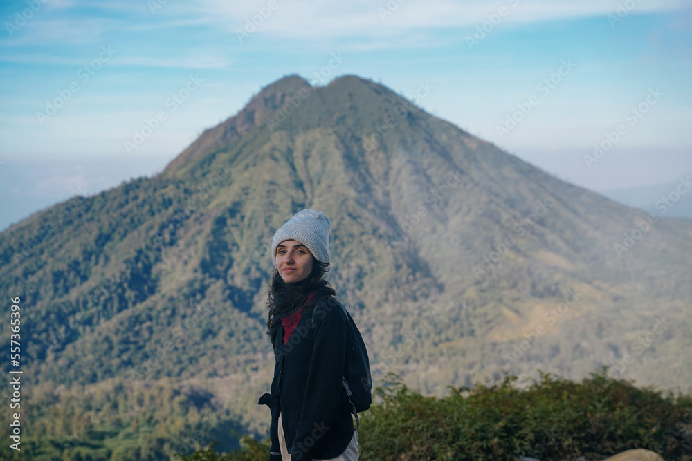 tourist girl in front of mount Merapi in Indonesia on the trail of Ijen volcano