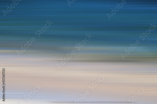 Dreamy abstraction of the sea at sunset with a blur effect. Dark ocean, Simple backdrop. Motion blur.