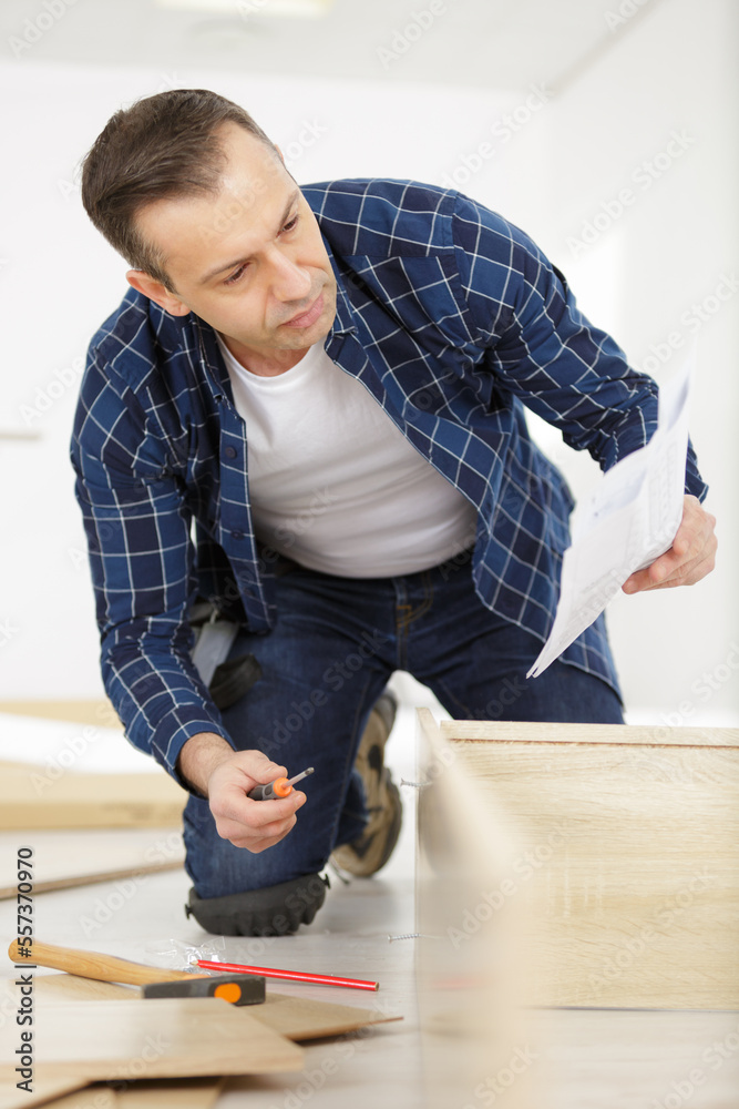 professional furniture assembly worker assembles shelf professional furniture assembly worker assembles shelf