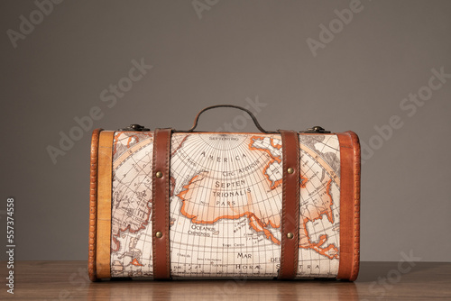 Wooden retro suitcase with world map on it