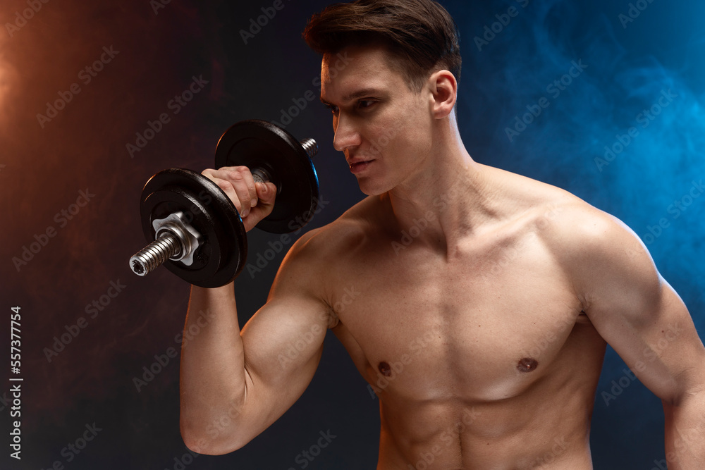 Photo of young man with good physique isolated on black background