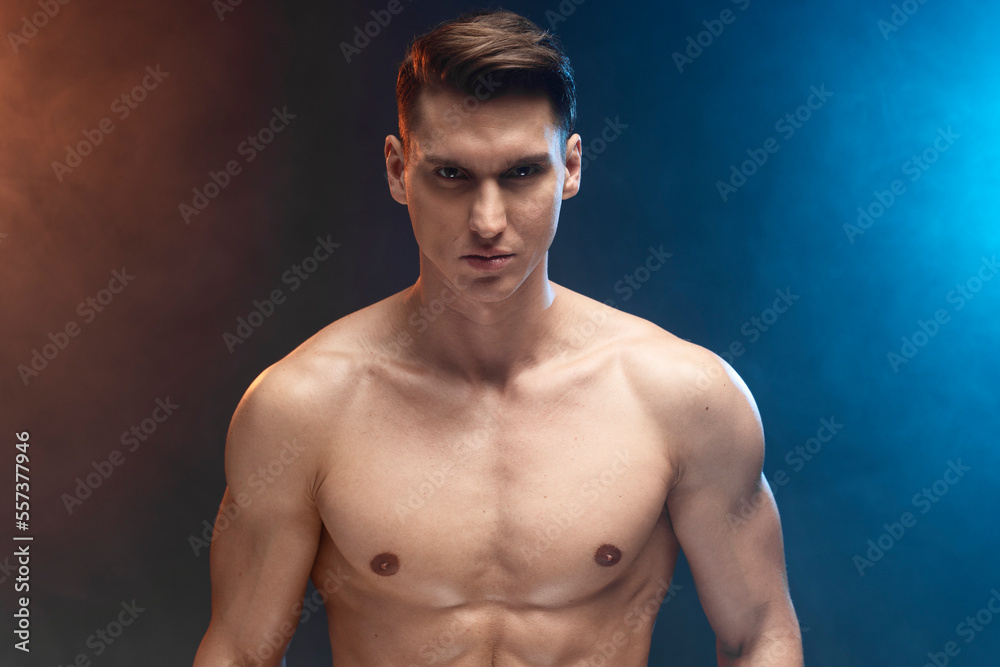 Portrait with copy space of attractive stunning man demonstrating muscular naked torso Portrait with copy space of attractive stunning man demonstrating muscular naked torso